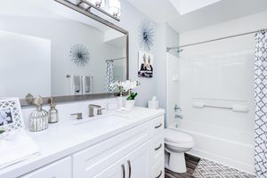 a kitchen with a sink and a mirror