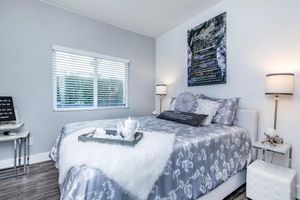 a bedroom with a bed in a room