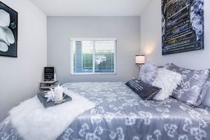 a bedroom with a bed in a room