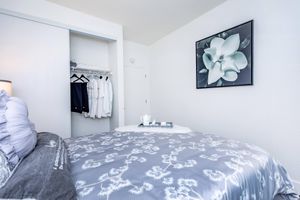 a bedroom with a bed in a room