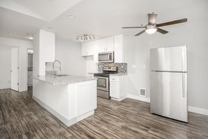 a kitchen with a sink and a refrigerator