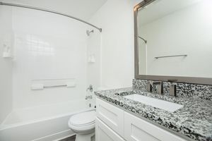 a kitchen with a sink and a mirror