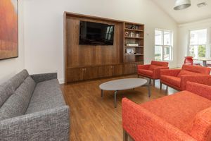 Branford Manor Apartments community room with couches and a TV