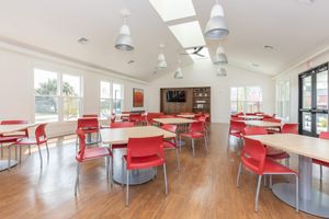 Branford Manor Apartments community room with red chairs