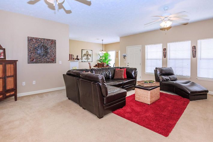 a living room filled with furniture and a flat screen tv