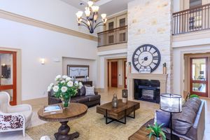 a living room filled with furniture and a clock