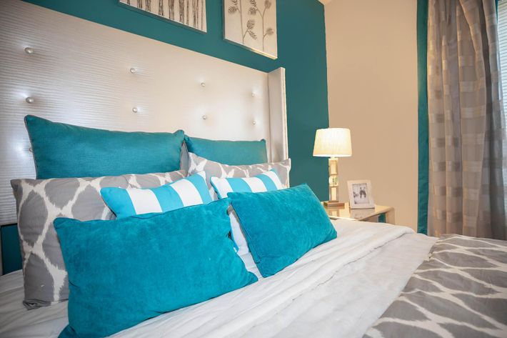 a blue and green bed in a room