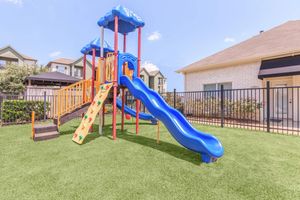 Children’s play area with blue slide at The Avenue apartments