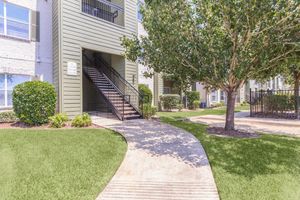 Exterior view of residential building with garage at The Avenue apartments