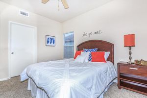 Furnished bedroom with ceiling fan 