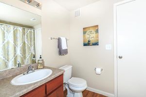 Bathroom with sink, toilet, and towel rack