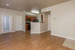 Large apartment living room with 9-foot ceilings and view of kitchen 