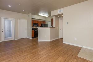 Large apartment living room with 9-foot ceilings and view of kitchen