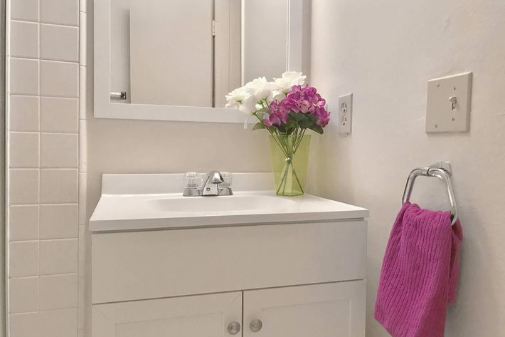 Bathroom sink with a pink towel