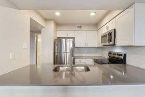 a large kitchen with stainless steel appliances