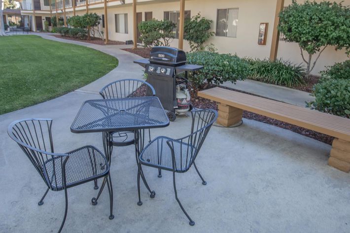 A table and chairs with a barbecue