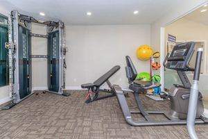 Modern clean fitness center gym with work out equipment and weight set