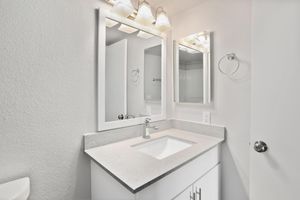 Modern bathroom sink vanity with a mirror and overhead lighting